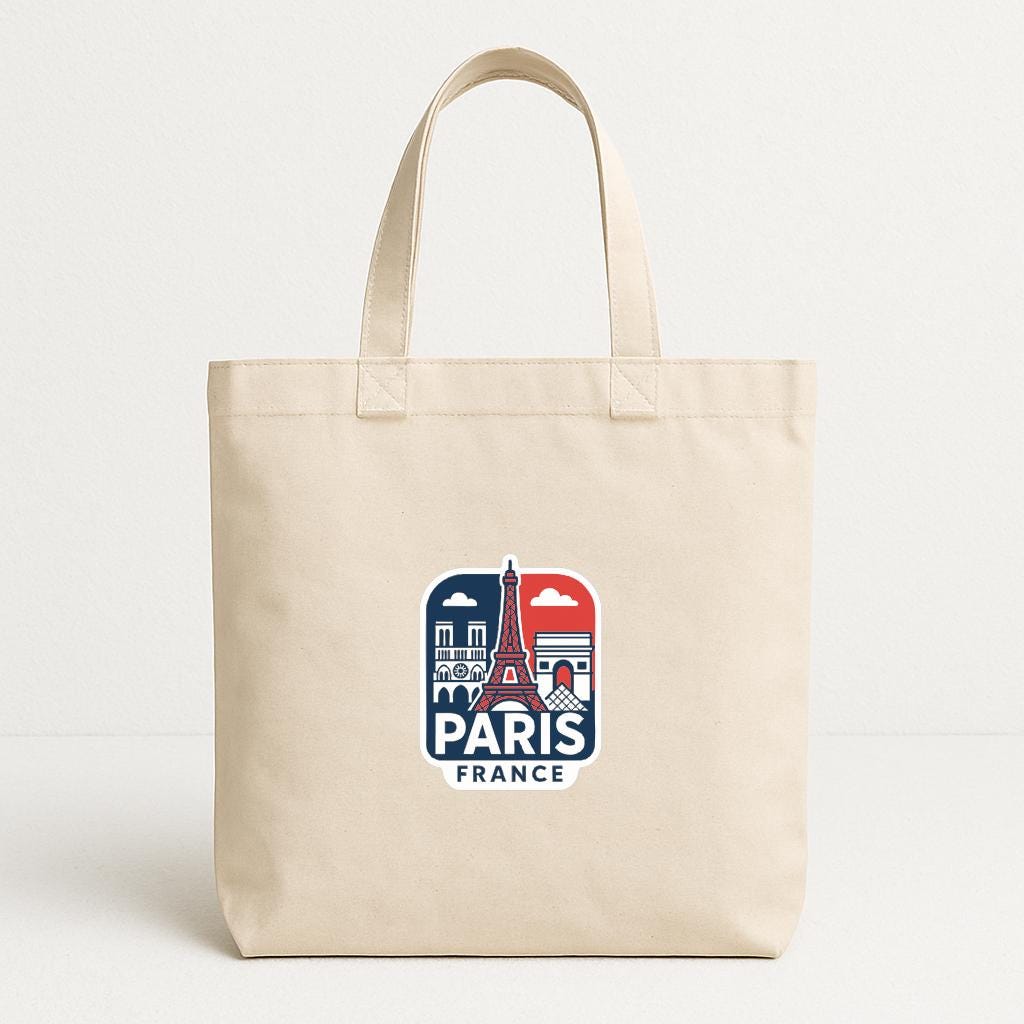 A beige tote bag with a graphic design featuring the Eiffel Tower and the text "PARIS FRANCE" printed on it.