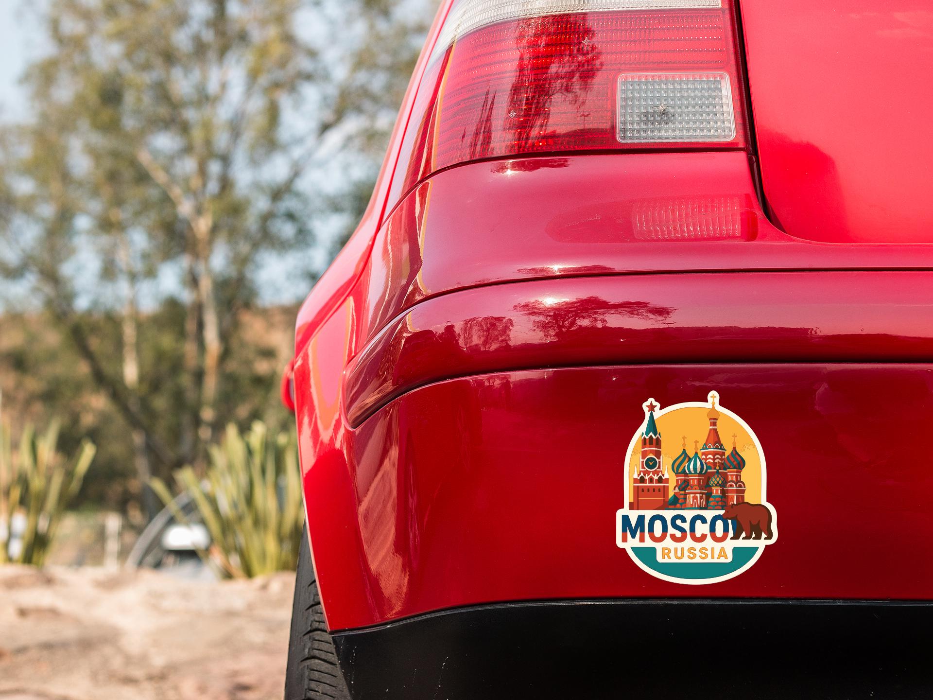 the rear end of a red car with a sticker on the trunk that features the logo of Moscow, Russia.