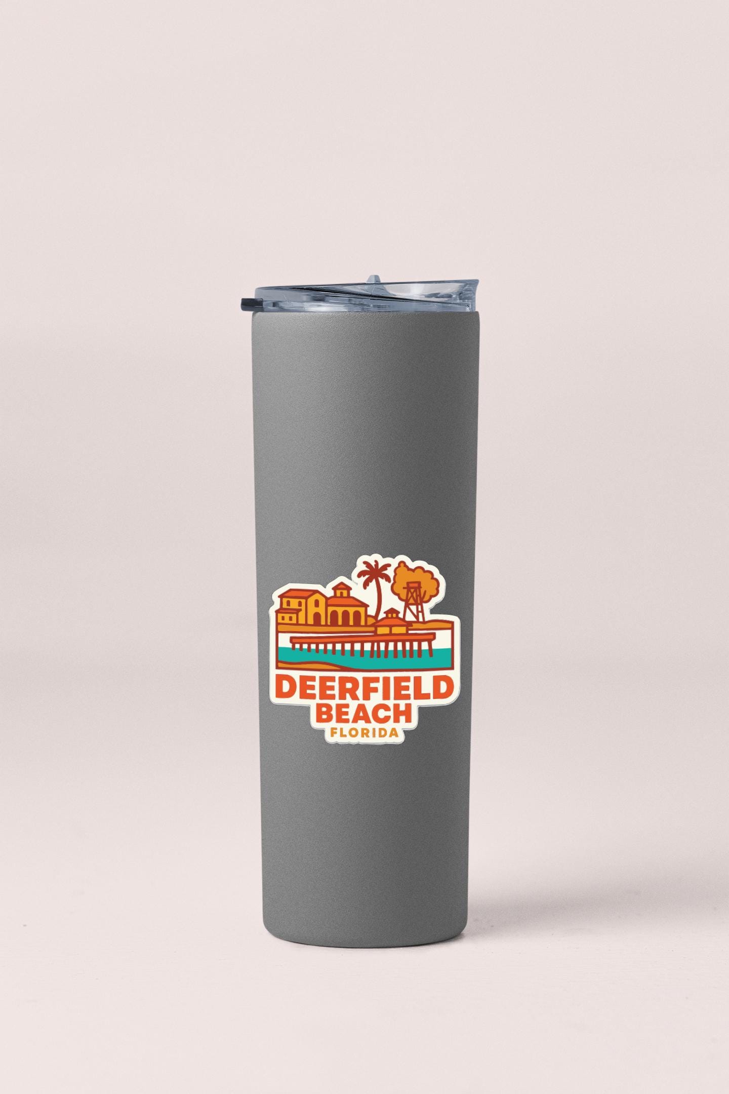 A gray insulated tumbler with a printed label that says "Deerfield Beach, Florida".