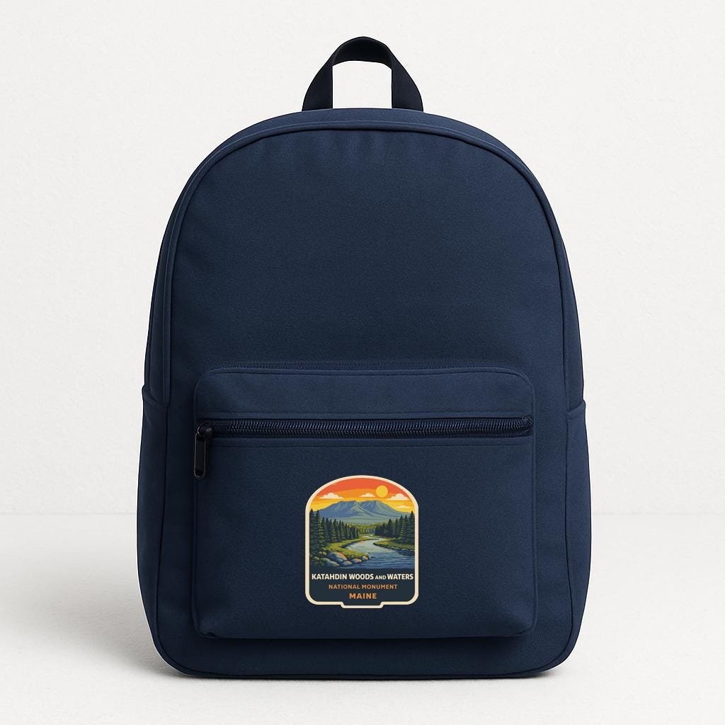 A navy blue backpack with a graphic design on the front pocket.