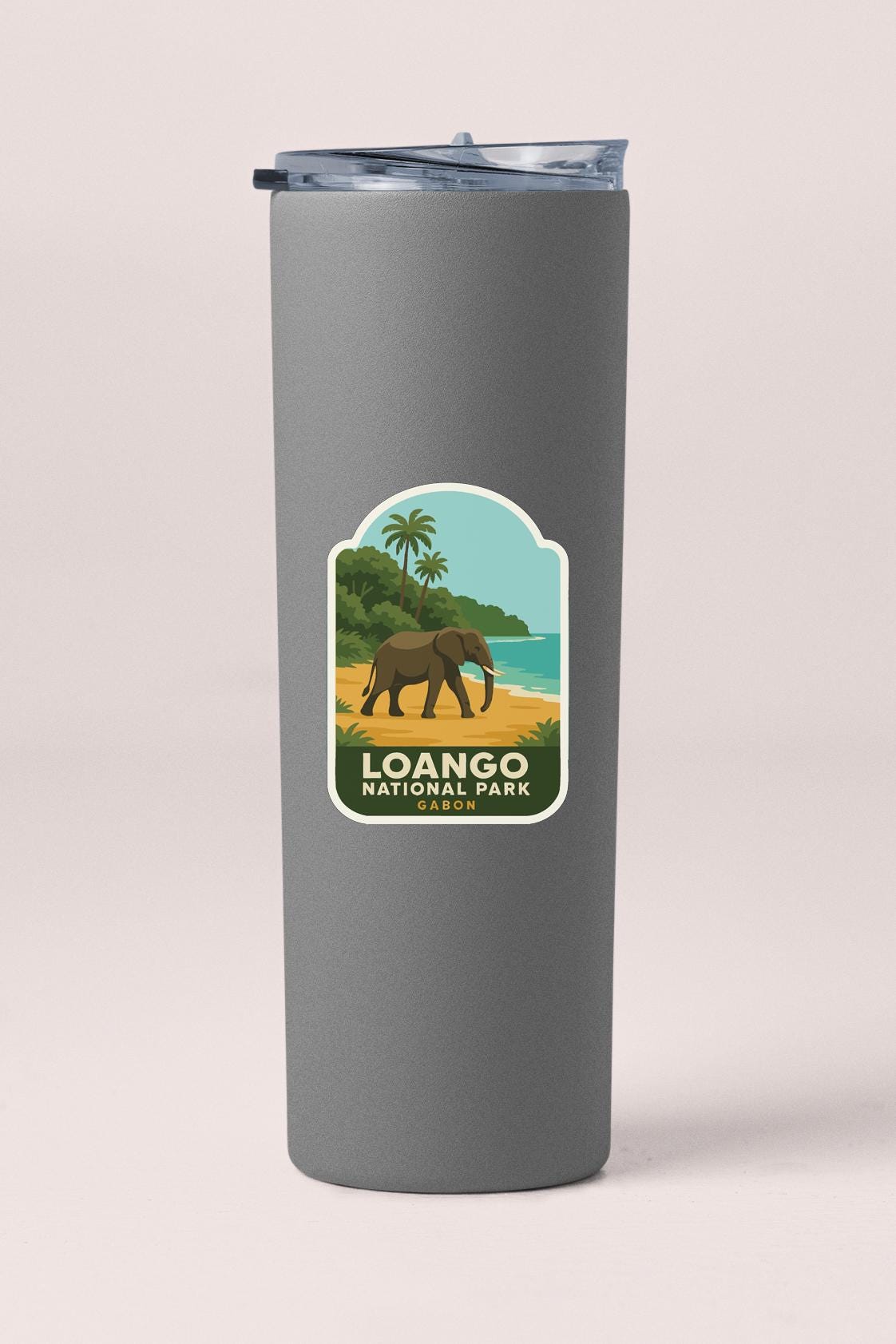 A gray cylindrical container with a label that features an illustration of an elephant and a tropical landscape, along with the text "Loango National Park Gacon".
