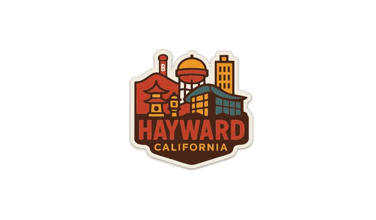 A sticker or emblem featuring the city of Hayward, California, with various landmarks and buildings depicted in a stylized manner.