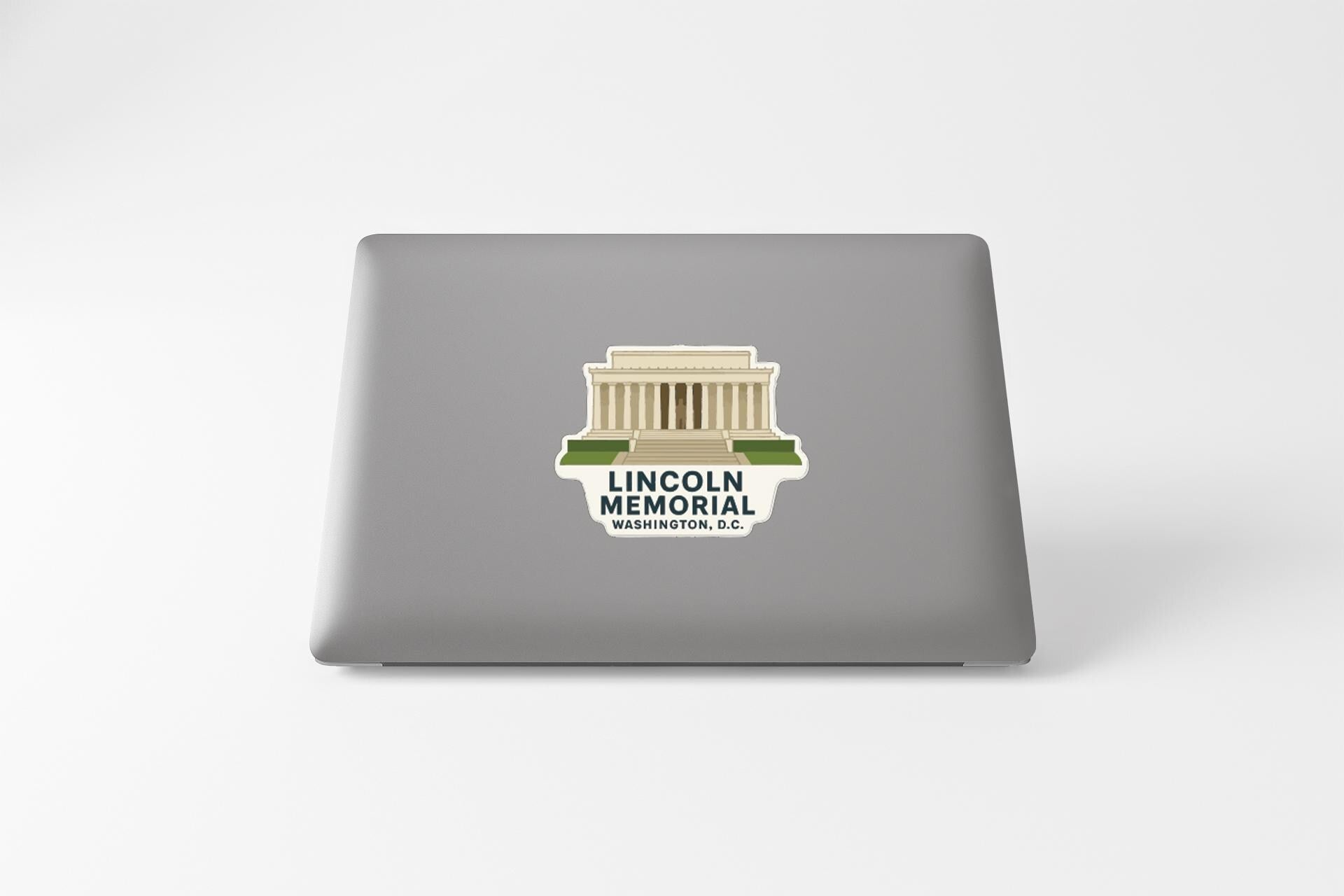 A sticker on the back of a laptop displaying the Lincoln Memorial in Washington, D.C.