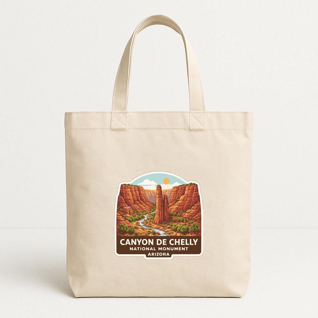 A beige tote bag with a printed design depicting the Canyon de Chelly National Monument in Arizona.
