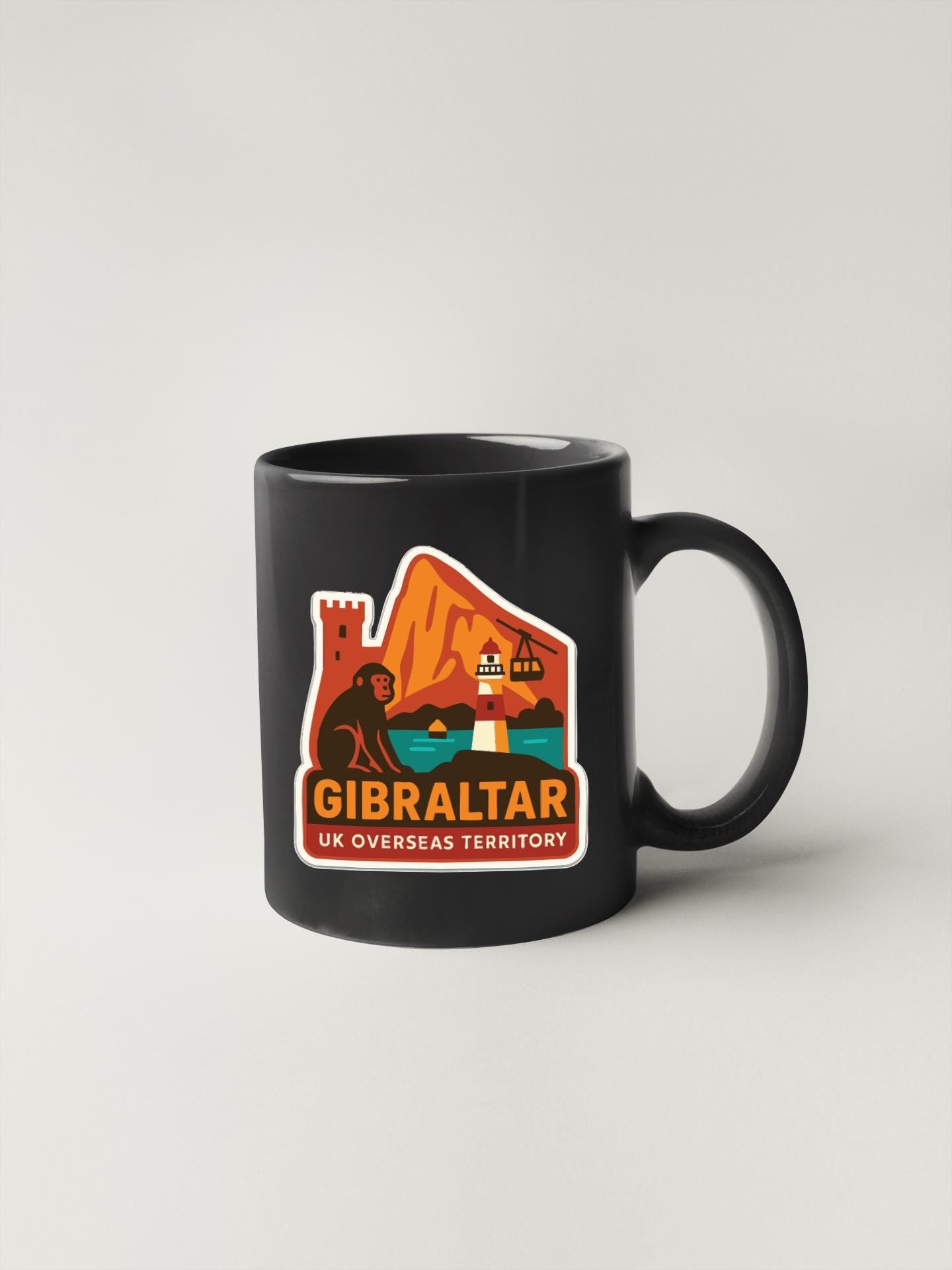 A black coffee mug with a colorful graphic depicting a castle, lighthouse, and mountains, along with the text "GIBRALTAR UK OVERSEAS TERRITORY".