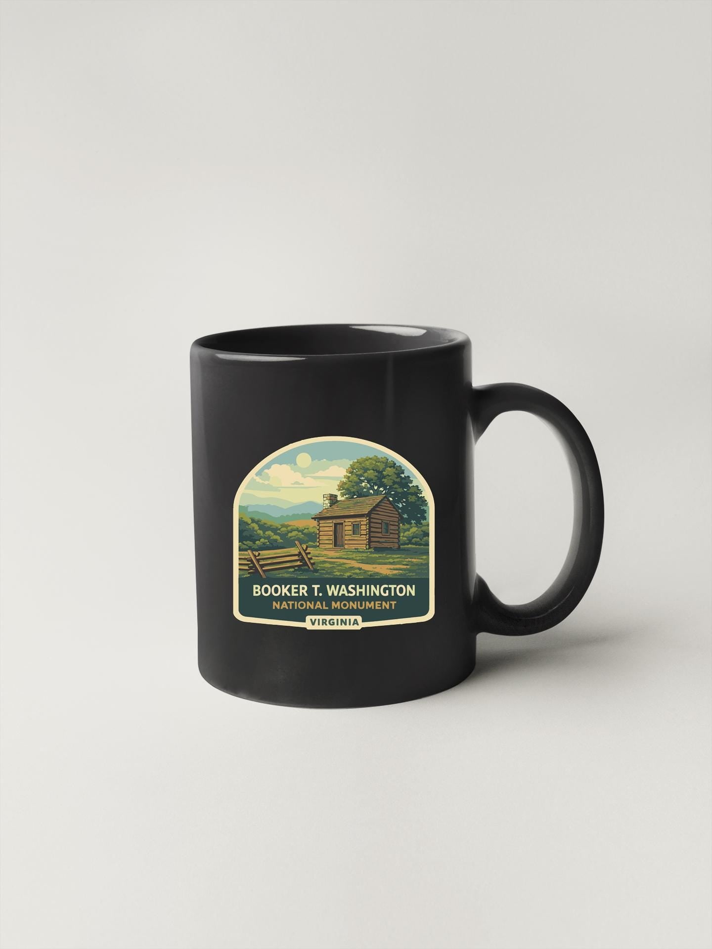 A black coffee mug with a label that says "BOOKER T. WASHINGTON NATIONAL MONUMENT WASHINGTON, WIS."