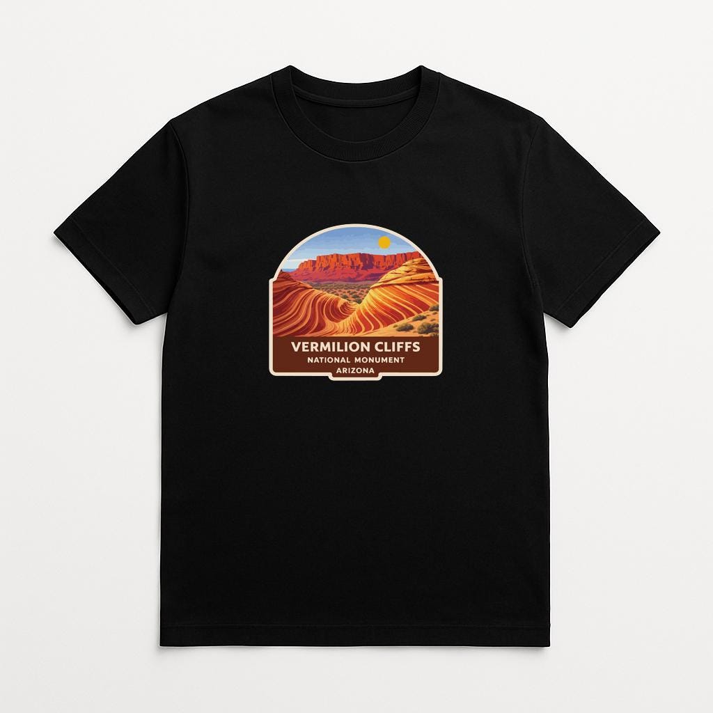 A black t-shirt with a graphic design depicting the Vermilion Cliffs National Monument in Arizona.