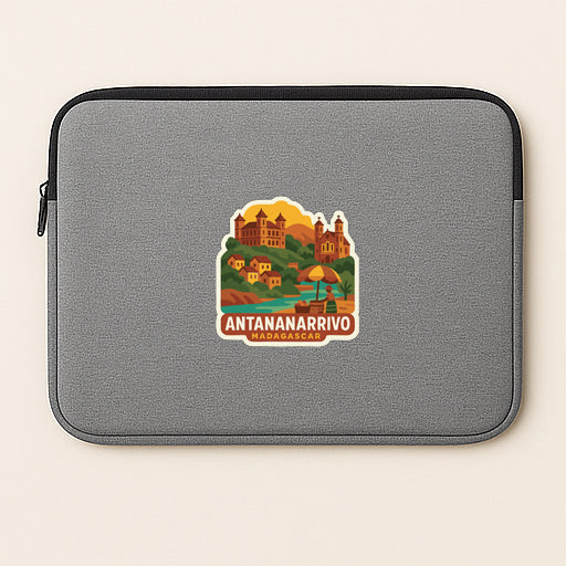A gray laptop sleeve with a sticker depicting a scenic view of Antananarivo, Madagascar.