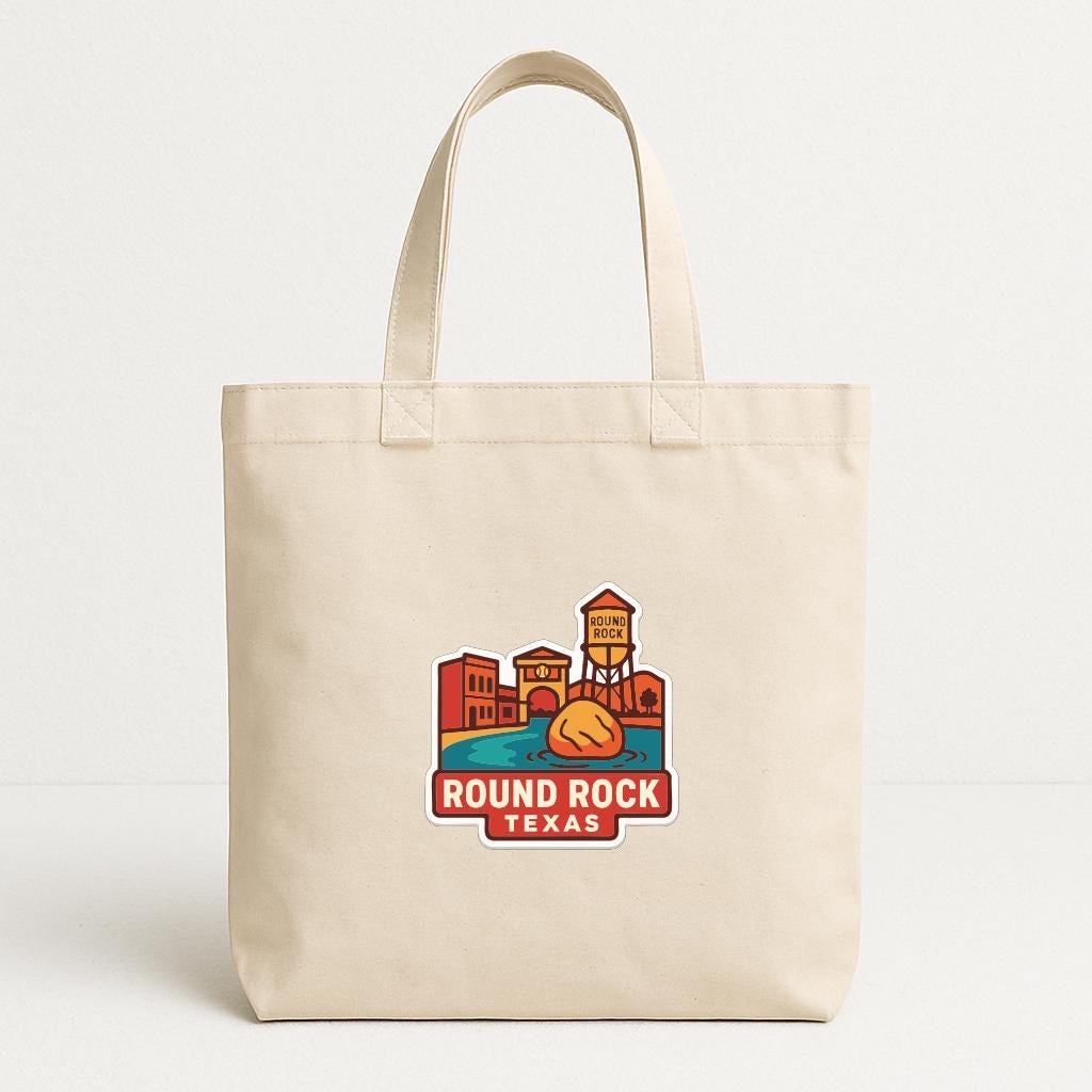 A beige tote bag with a graphic design depicting a cityscape and the text "Round Rock, Texas" printed on it.