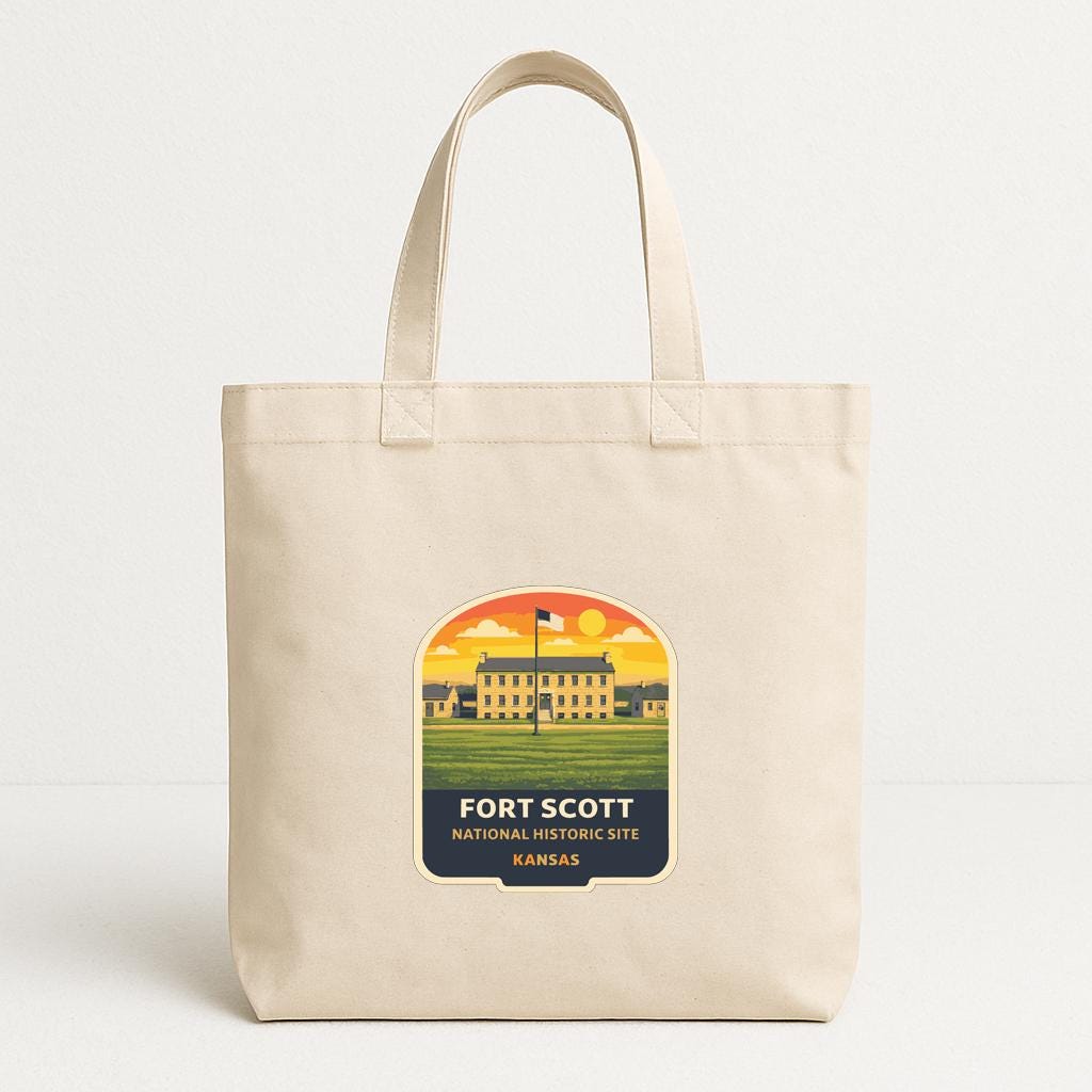 A beige tote bag with a printed label that says "FORT SCOTT NATIONAL HISTORIC SITE KANSAS".
