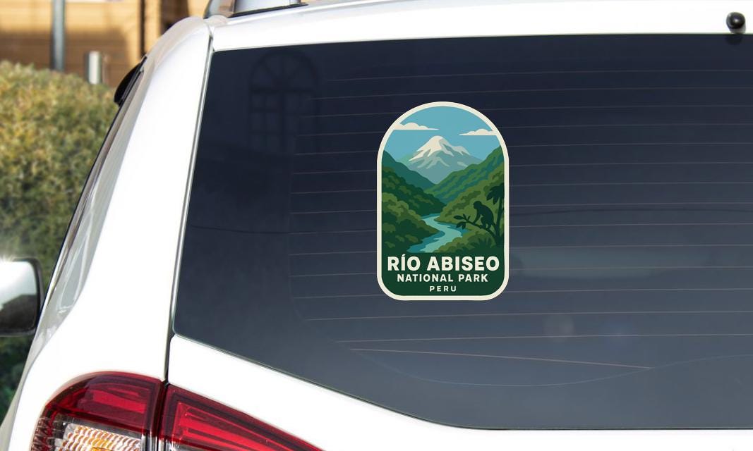 A sticker on the rear window of a car that says "Rio Abisito National Park Peru".