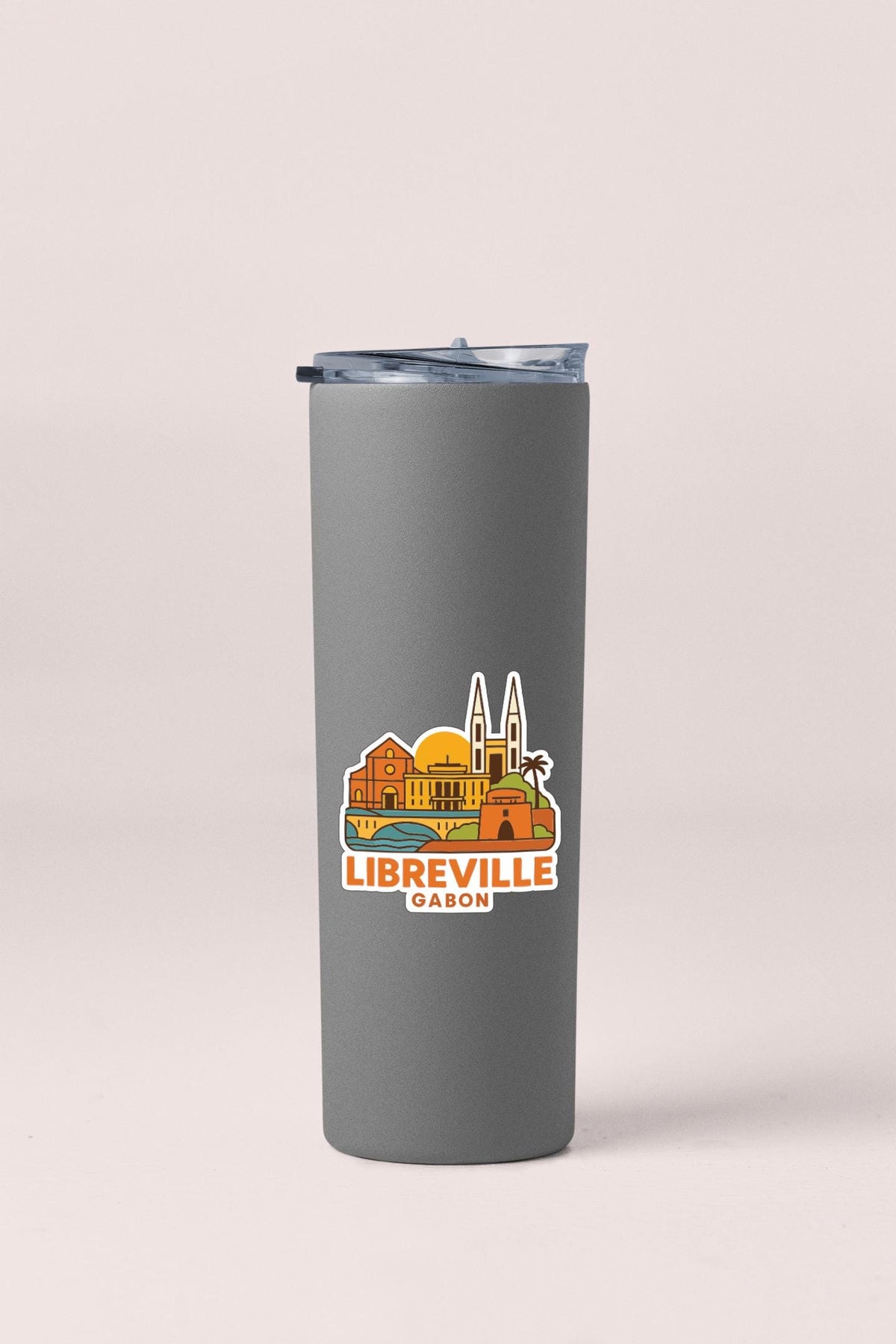 A gray insulated tumbler with a printed image of the town of Libreville, Gabon, on it.