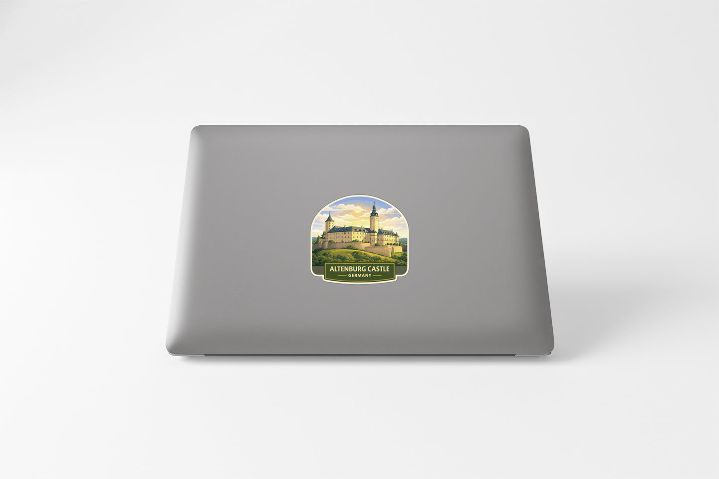 a sticker of a castle on the back of a laptop.