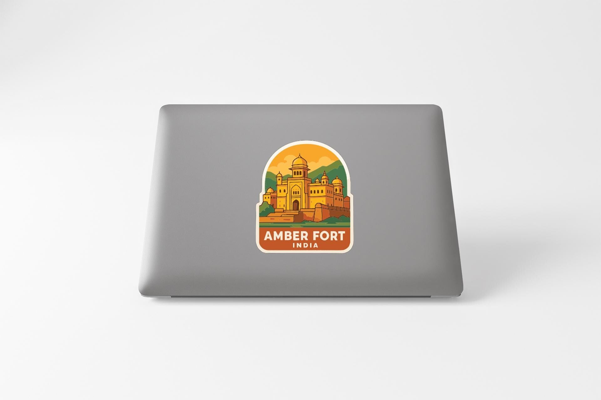 a sticker or decal of the Amber Fort in India on the back of a laptop computer.