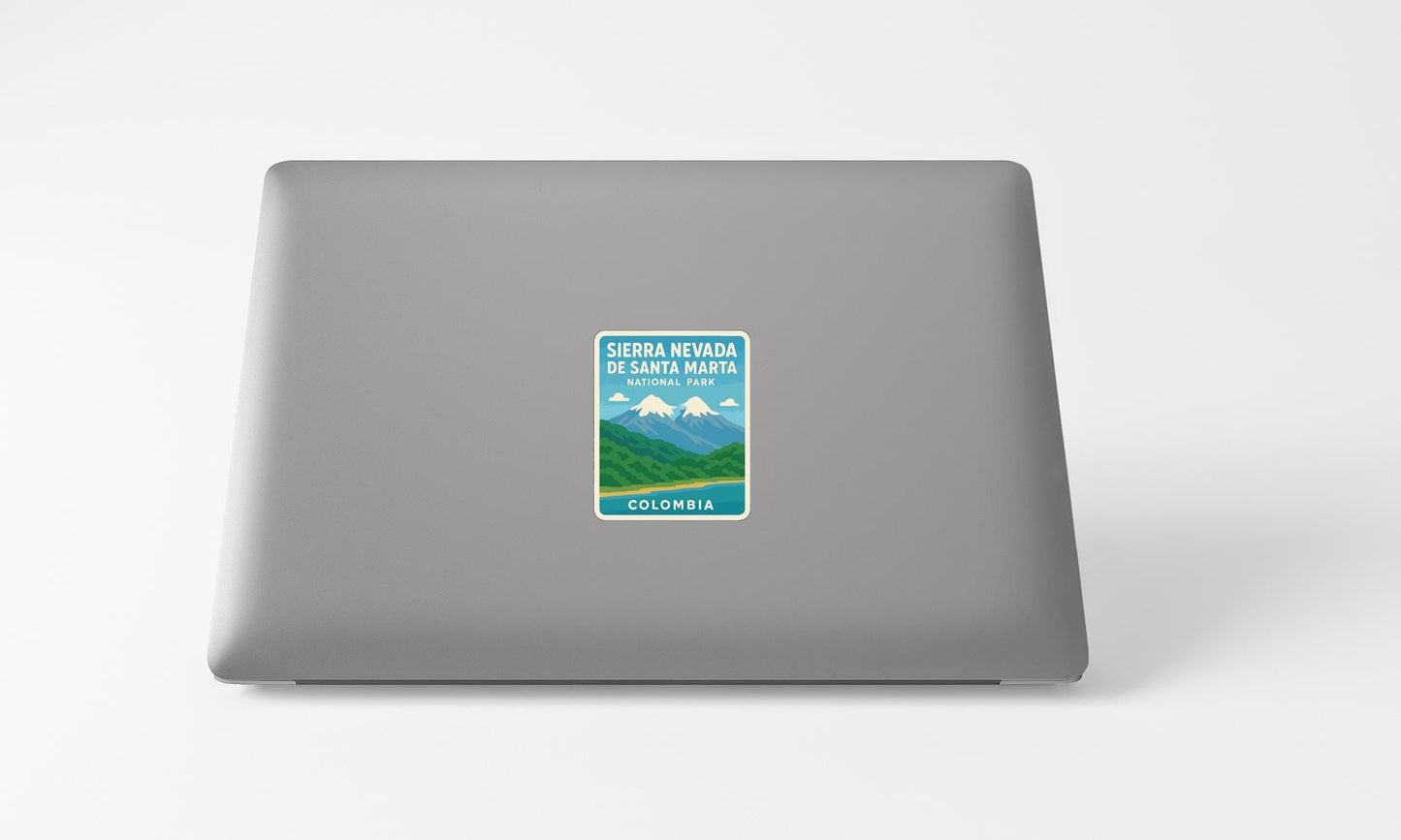 A sticker on the back of a laptop displaying the text "Sierra Nevada DE Santa Maria NATIONAL PARK COLOMBIA".