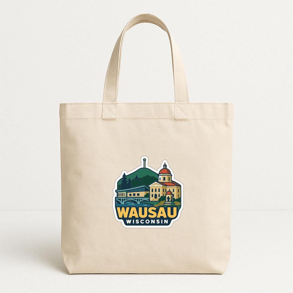 A beige tote bag with a graphic design featuring a building and the text "Wausau Wisconsin" printed on it.