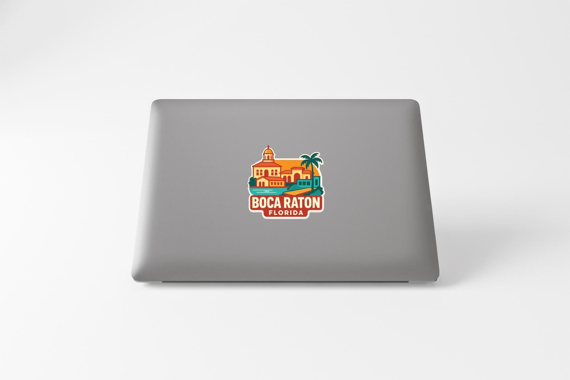 a sticker with a colorful illustration of a building and palm trees, along with the text "BOCA RATON FLORIDA".