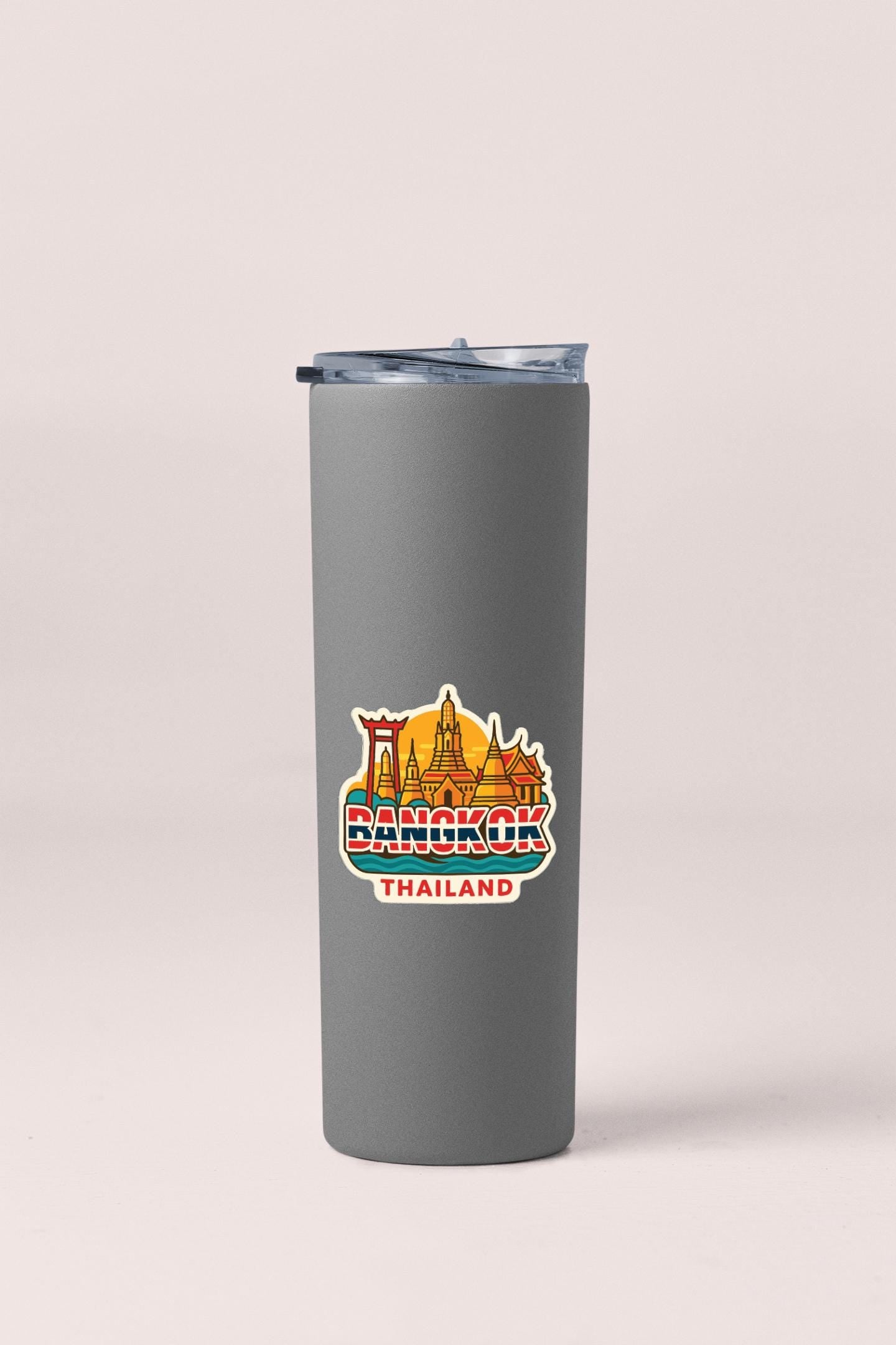 A gray insulated tumbler with a printed sticker depicting the skyline of Bangkok, Thailand.