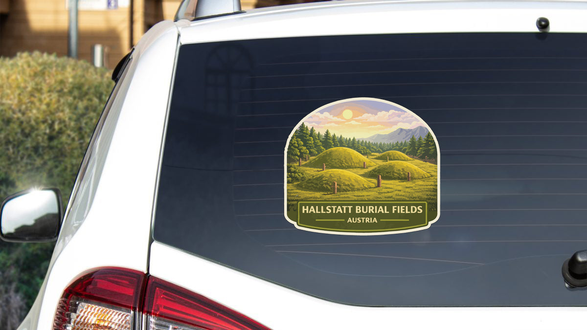 a sticker on the rear window of a car that displays a scenic landscape with rolling hills, trees, and a sunset.