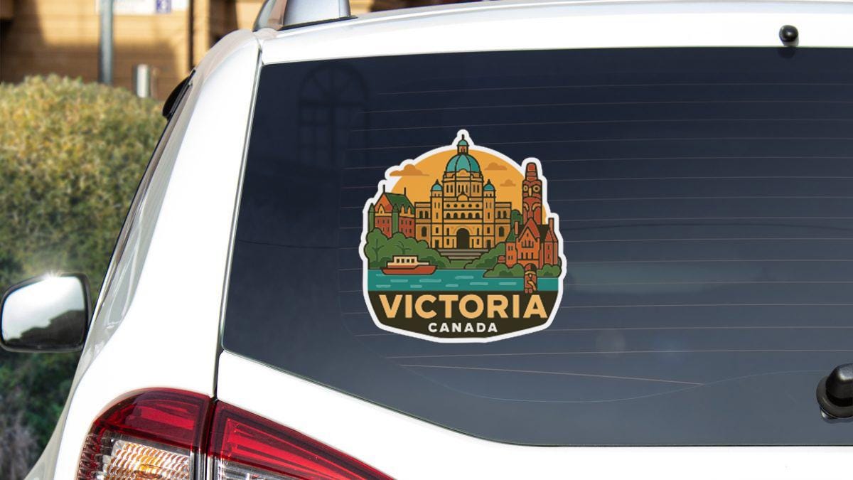 A sticker on the rear window of a car that features an illustration of Victoria, British Columbia, Canada.