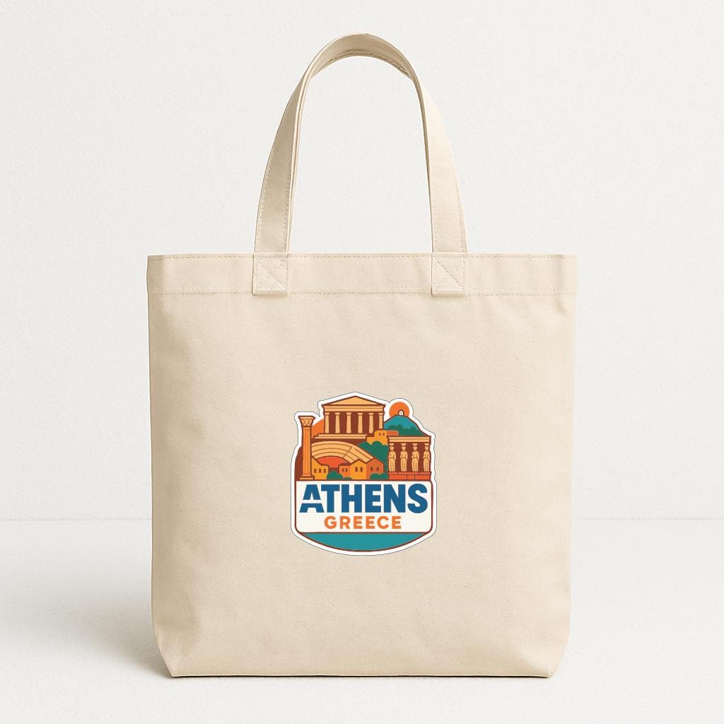 A beige tote bag with a graphic design depicting the city of Athens, Greece.