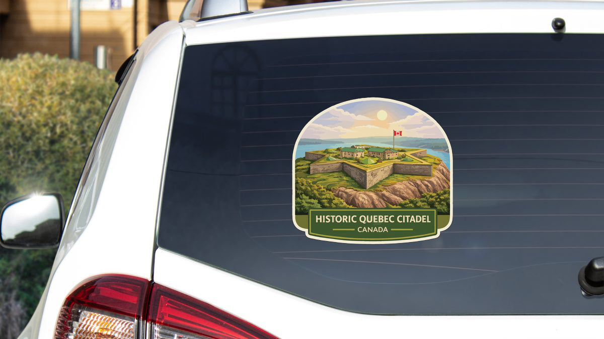 A sticker on the rear window of a car that features an illustration of the historic Quebec Citadel in Canada.