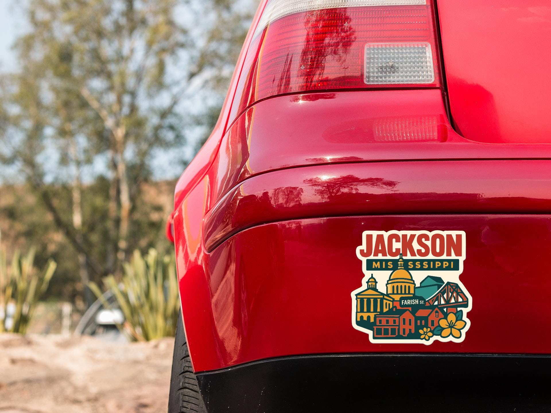 the rear end of a red car with a sticker on the back window that says "JACKSON MIS & SSIPPI".