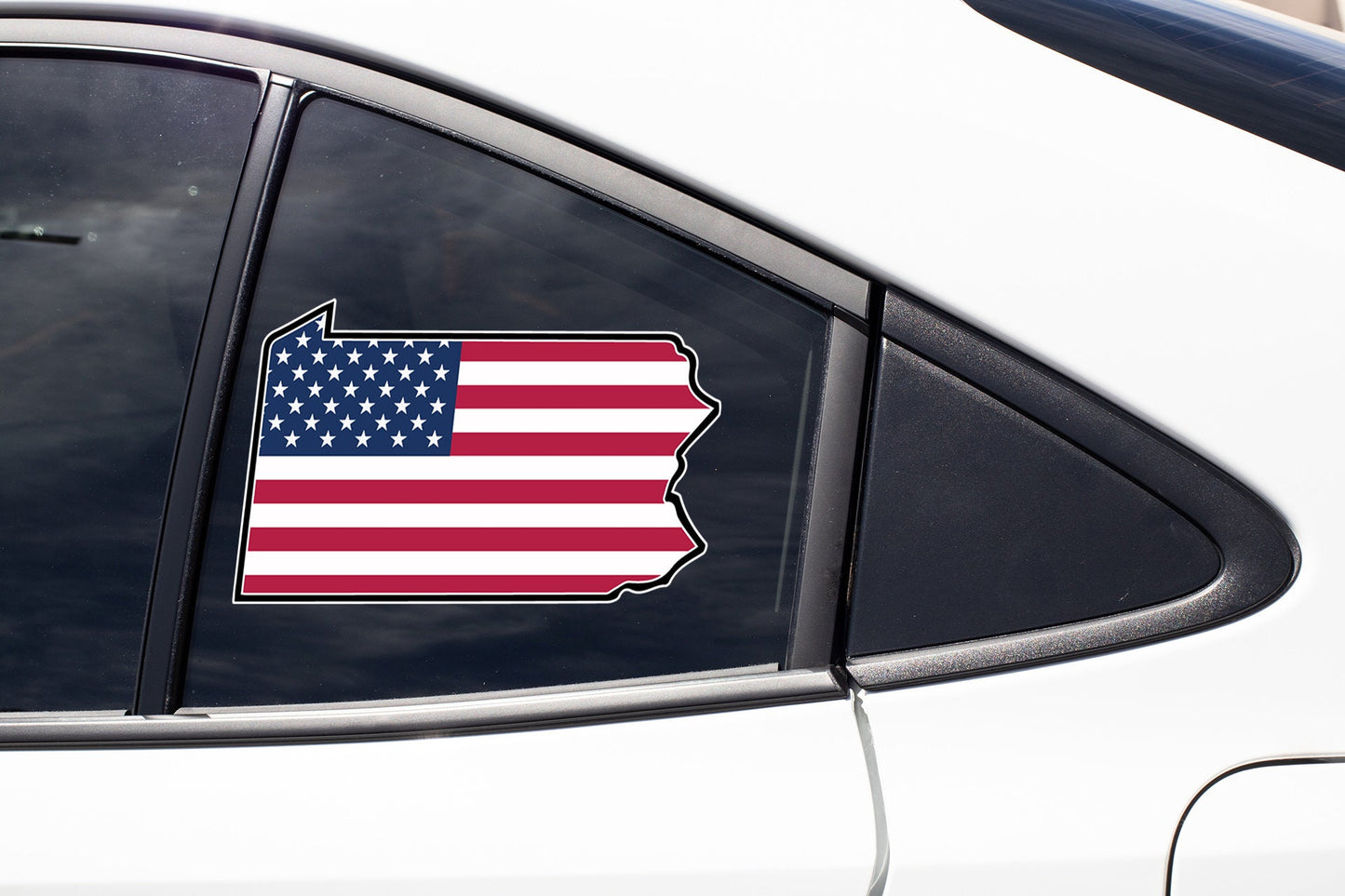 an american flag sticker on a car window