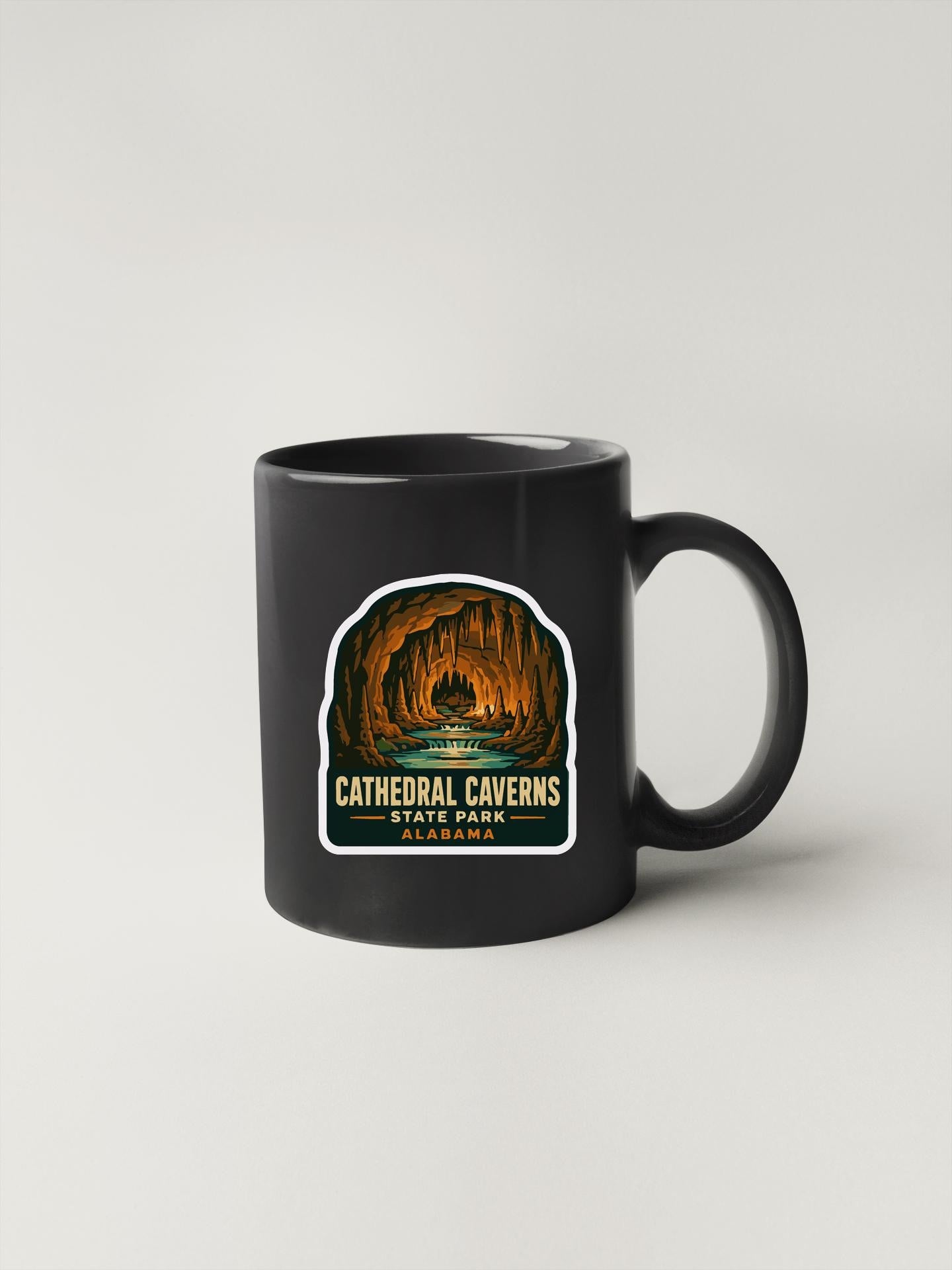 A black coffee mug with a label that says "Cathedral Caves State Park Alabama".