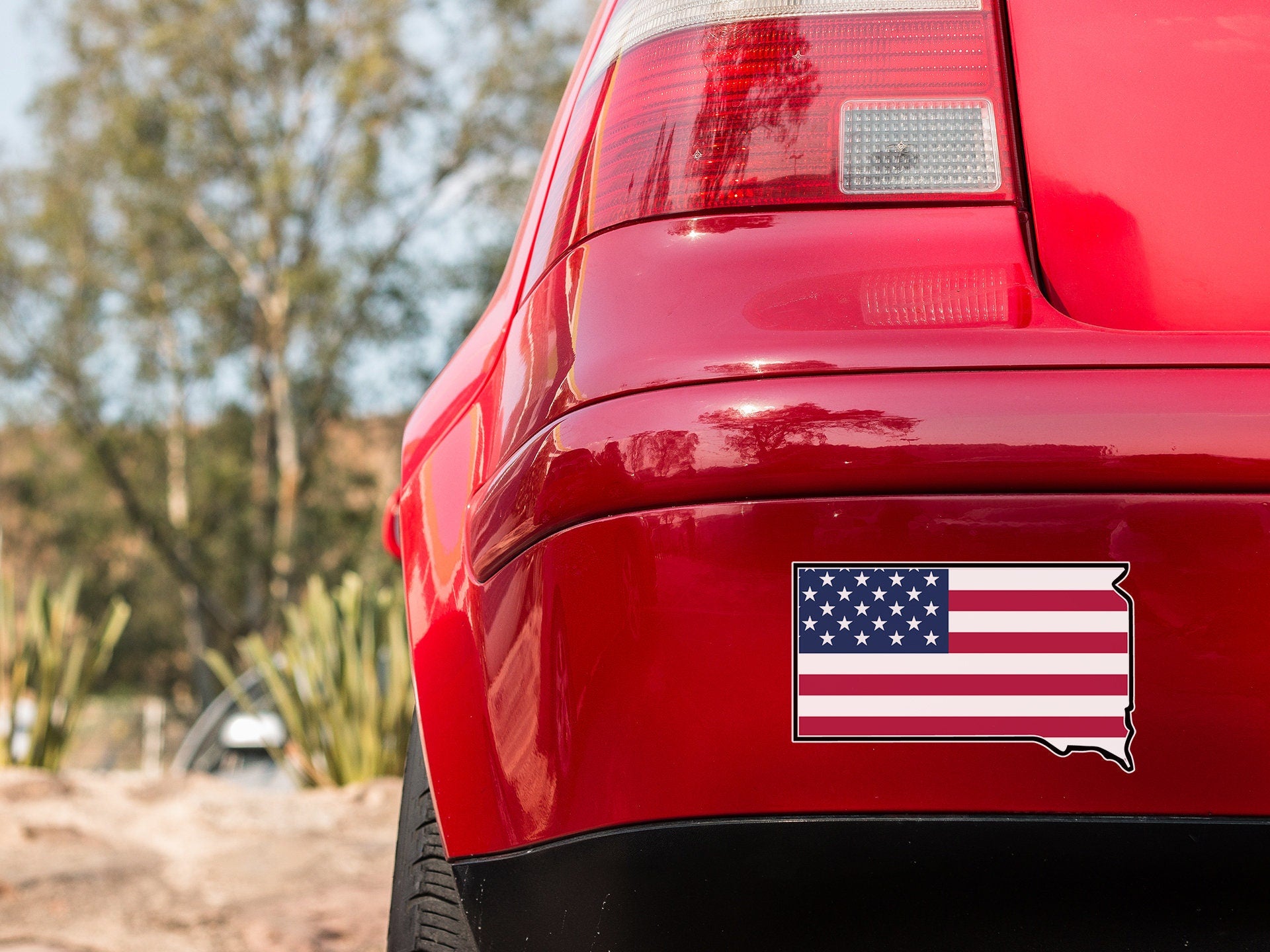 a red car with an american flag sticker on it