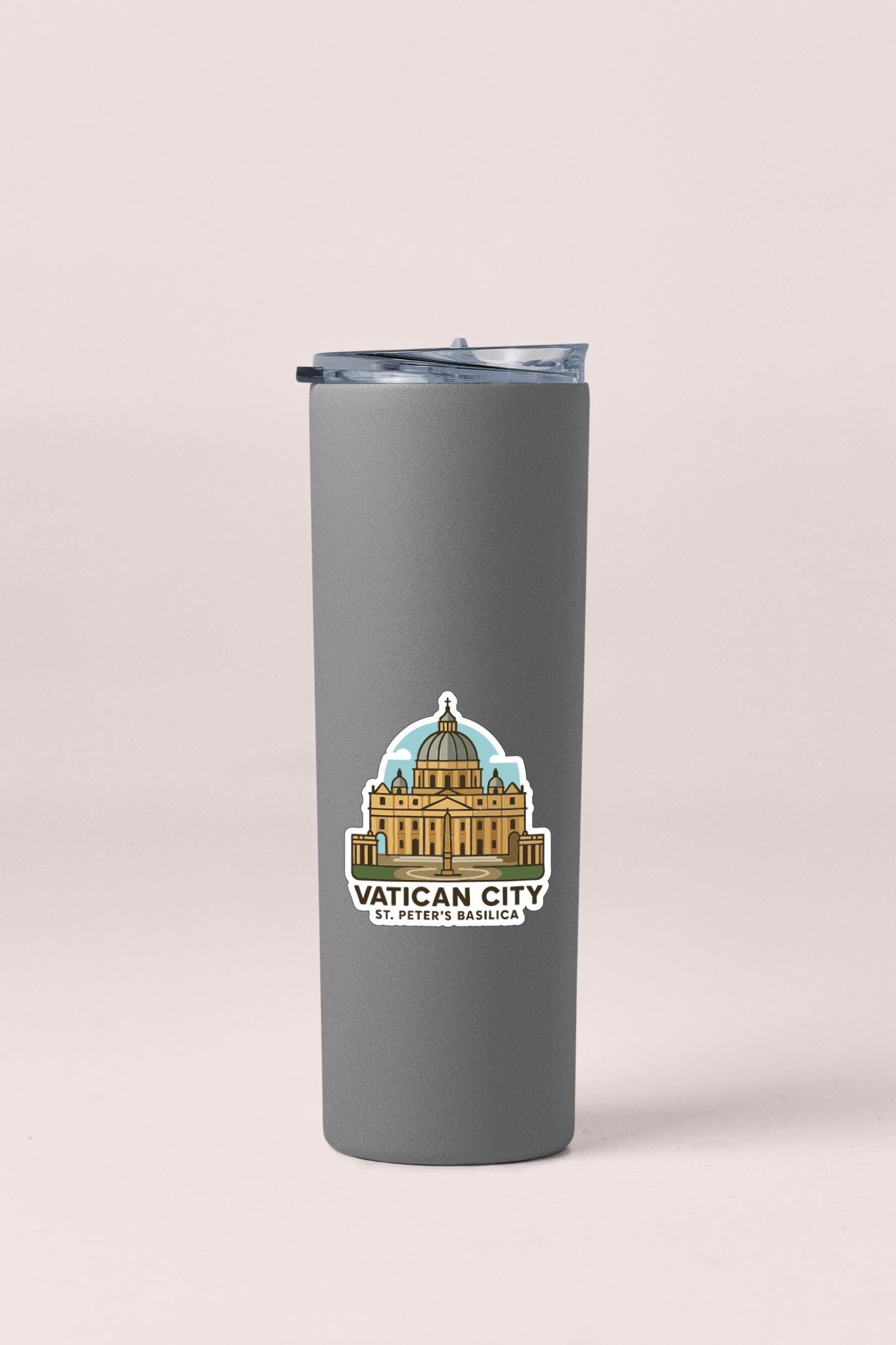 A gray insulated tumbler with a sticker depicting the Vatican City and St. Peter's Basilica.