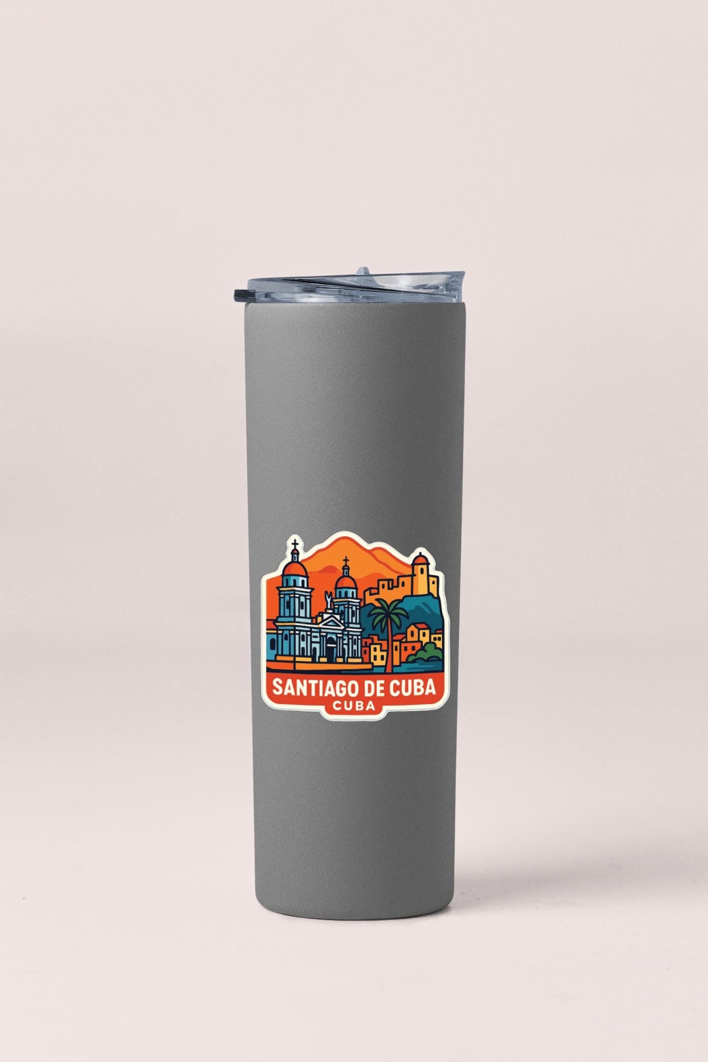 A gray insulated tumbler with a sticker depicting the skyline of Santiago de Cuba.
