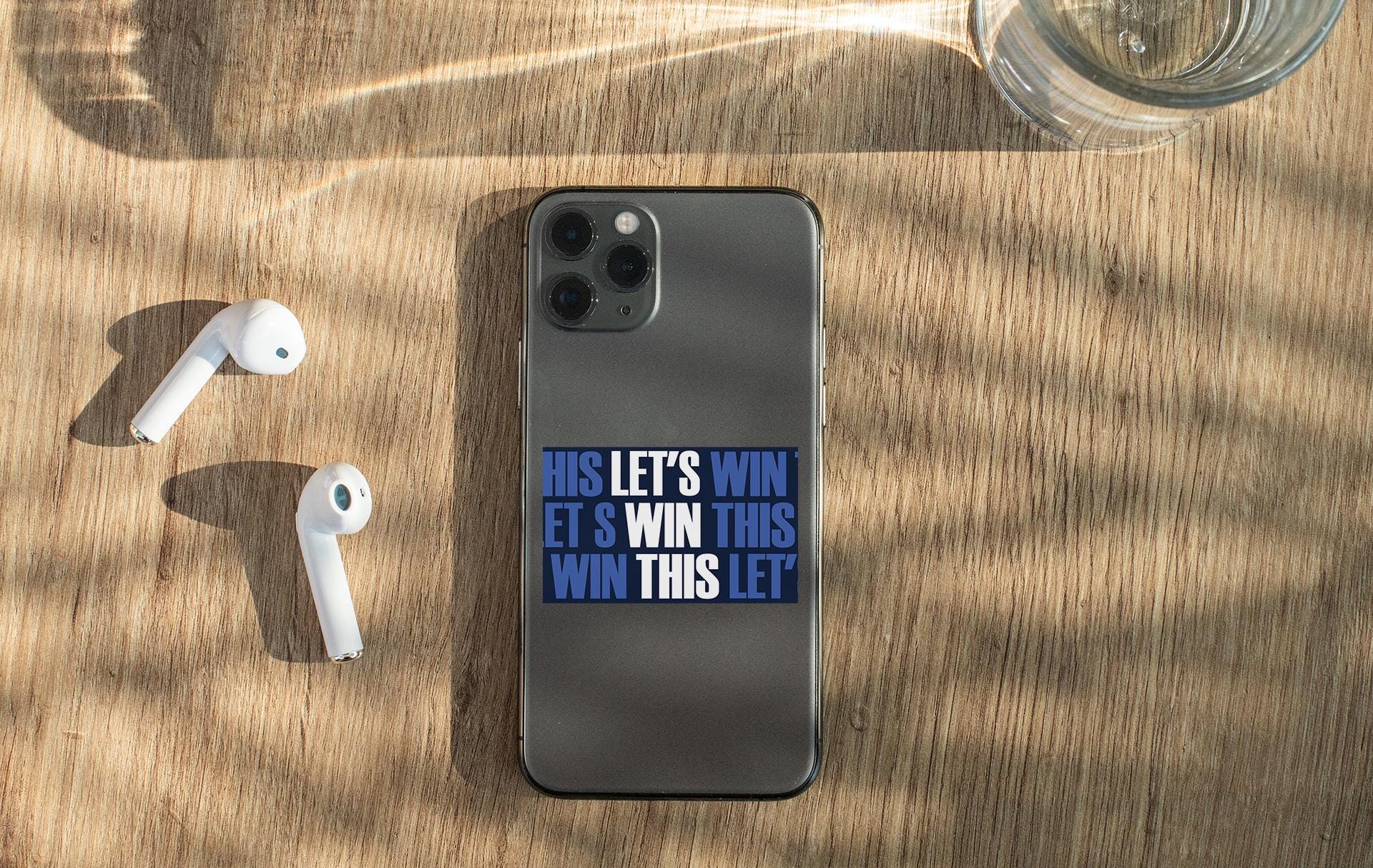 a cell phone and ear buds sitting on a table