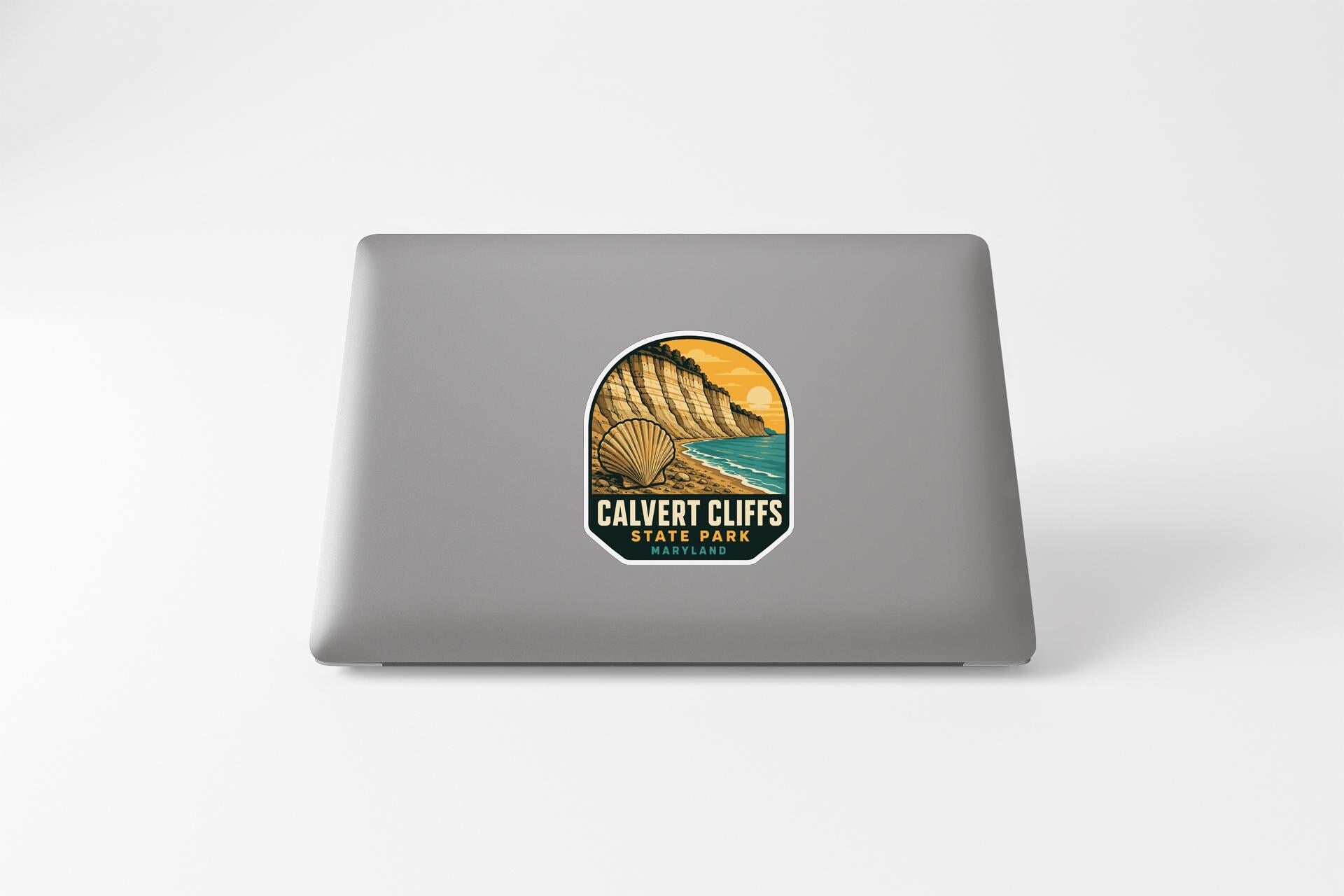a sticker with a scenic landscape of cliffs and a beach, along with the text "CALVET CLIFFS STATE PARK".