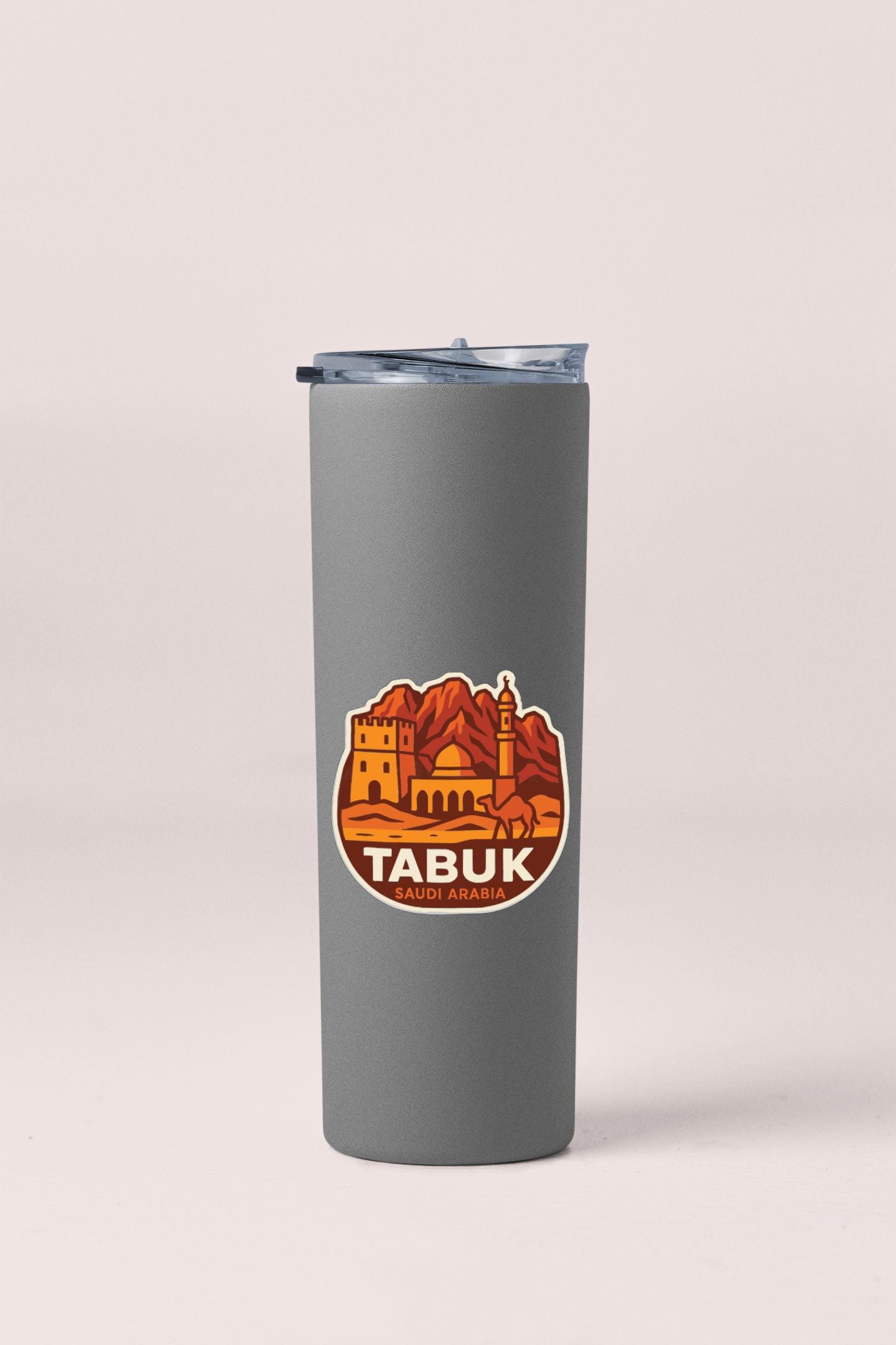 A gray insulated tumbler with a lid and a circular sticker featuring an illustration of Tabuk, a famous landmark in Sabah, Malaysia.