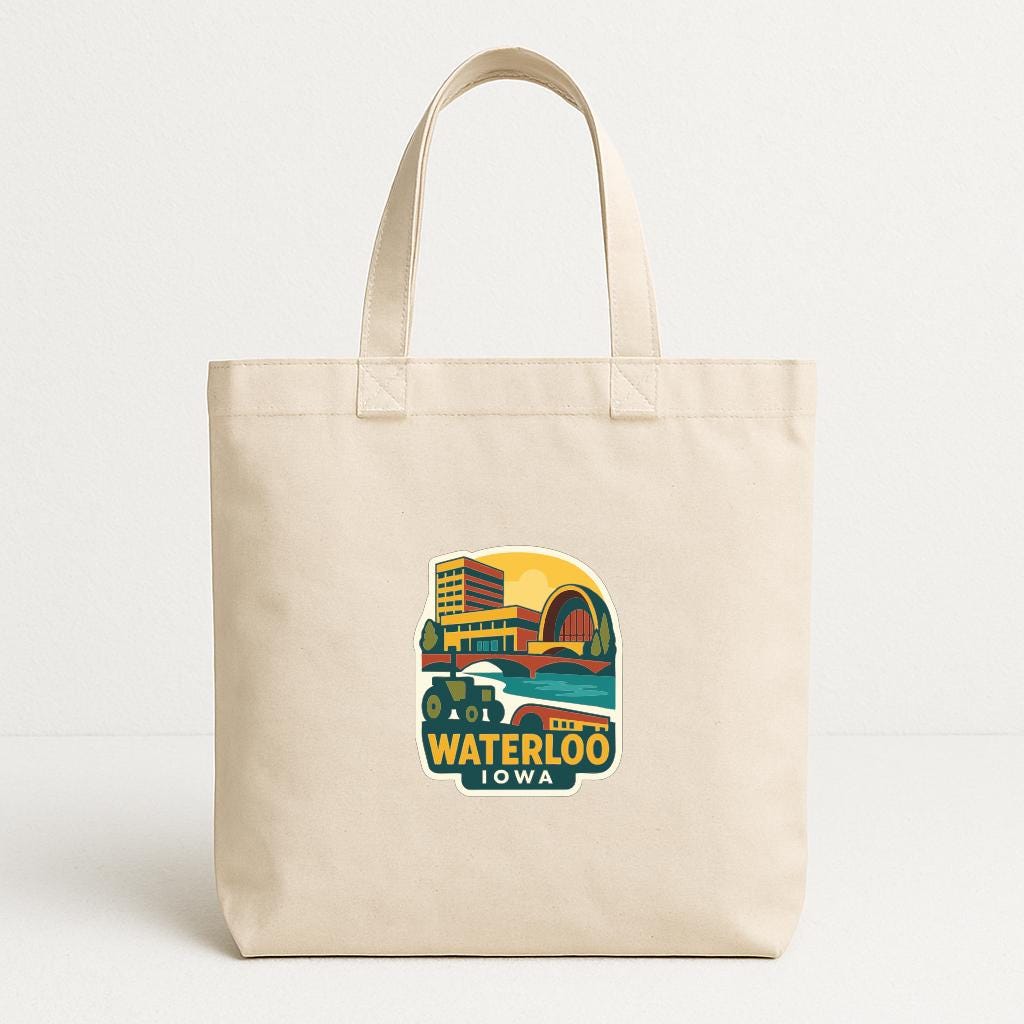A beige tote bag with a printed design depicting a cityscape and the text "The Waterloo, Iowa" printed on it.