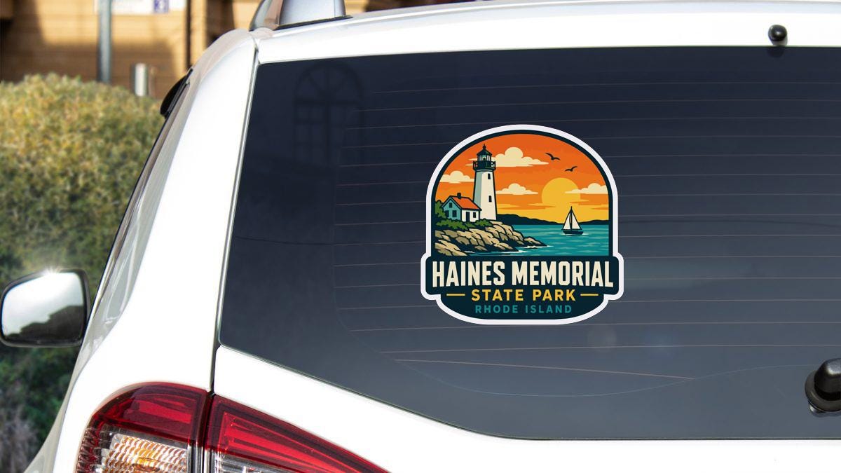 a sticker on the rear window of a vehicle, depicting a lighthouse and a sailboat, with the text "HAINES MEMORIAL STATE PARK RHODE ISLAND" printed on it.