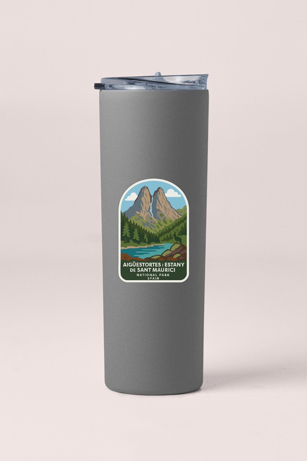 A gray cylindrical thermos with a label featuring an illustration of a mountain landscape and a river.