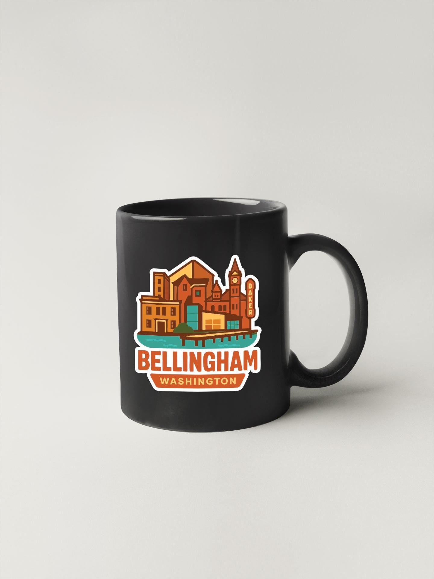 A black coffee mug with a colorful graphic design depicting the city of Bellingham, Washington.