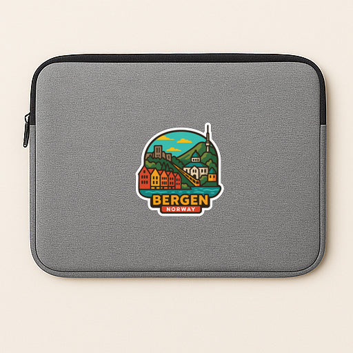 A gray laptop sleeve with a sticker depicting a scenic view of Bergen, Norway.