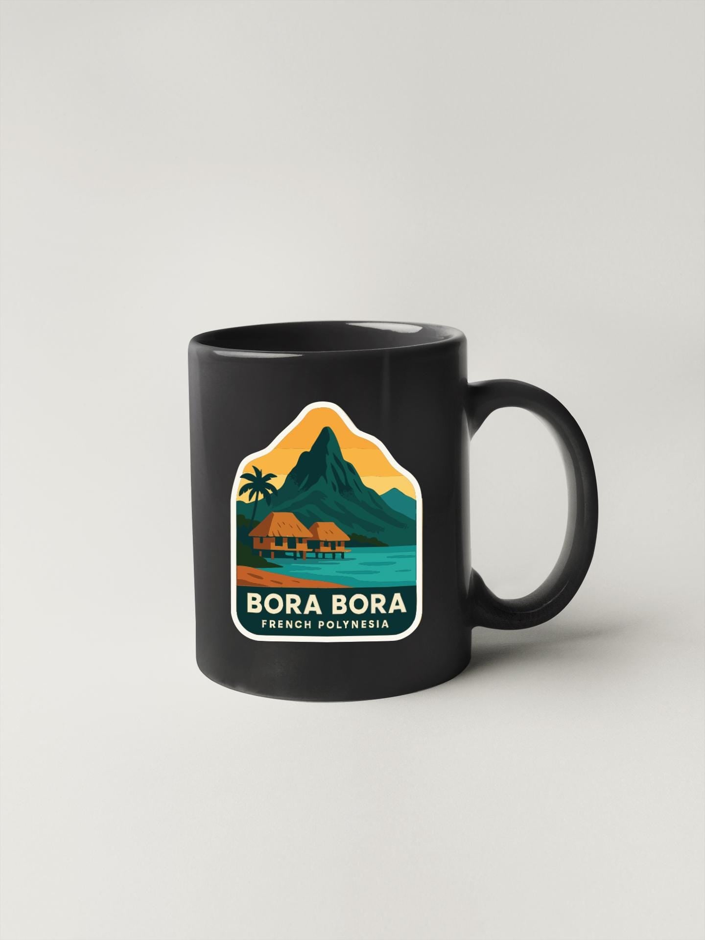 A black coffee mug with a tropical island landscape and palm trees printed on it, along with the text "BORA BORA FRENCH POLYTECHIA".