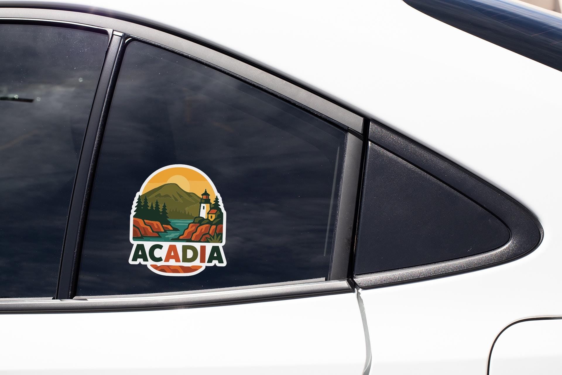 A sticker on the side of a car window that says "ACADIA".