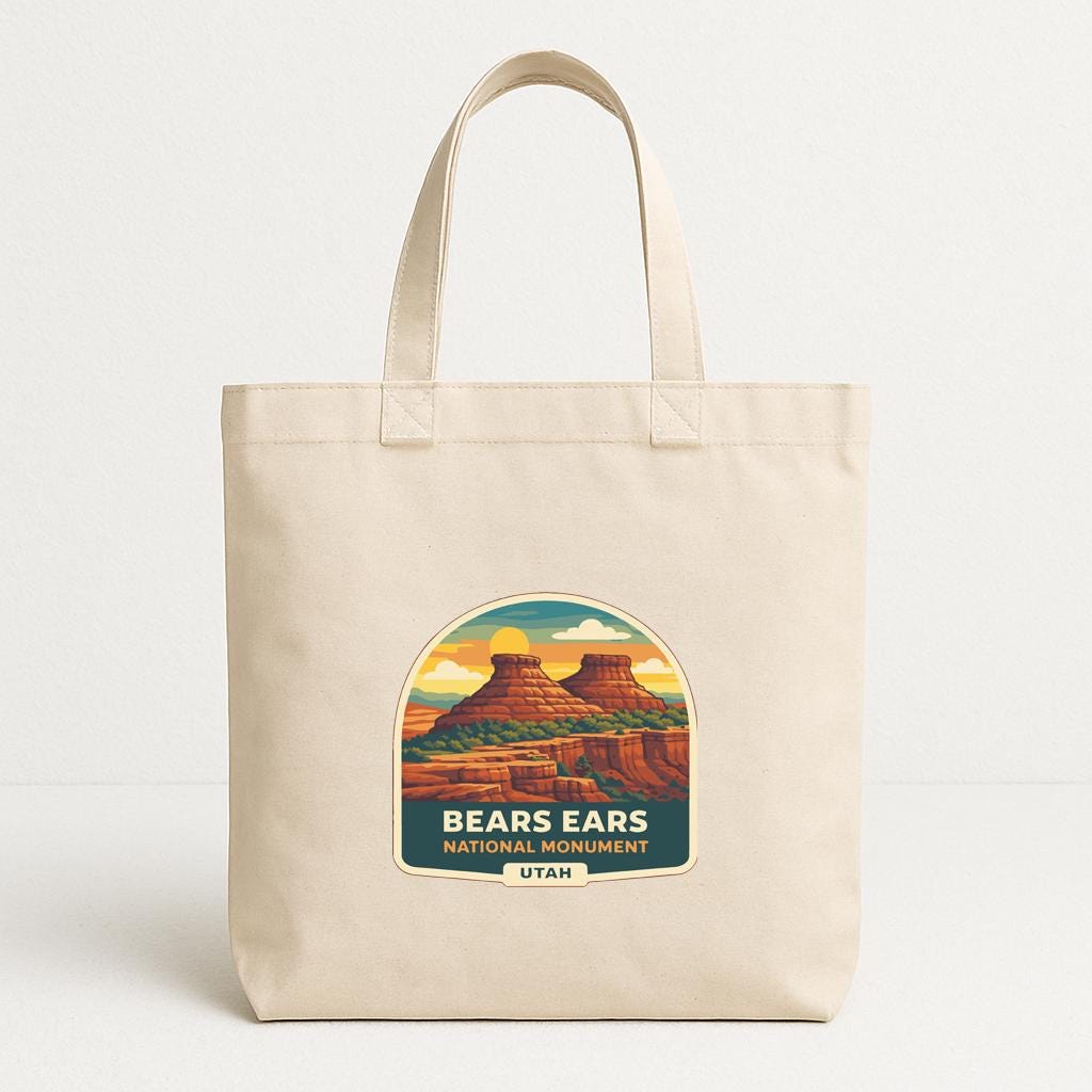 A beige tote bag with a graphic design depicting the Bears Ears National Monument in Utah.