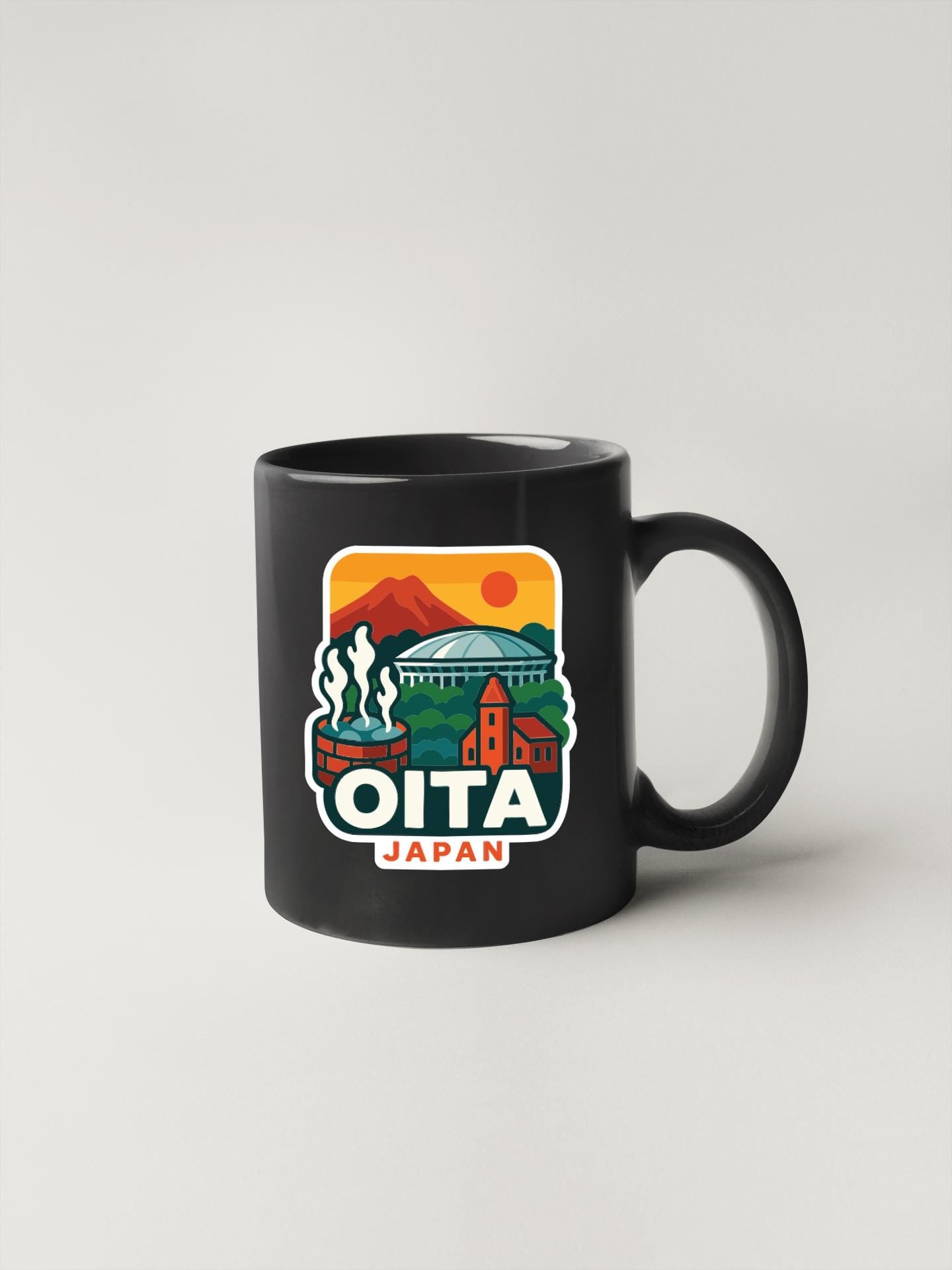 A black coffee mug with a colorful illustration of a cityscape and the text "OITA JAPAN" printed on it.