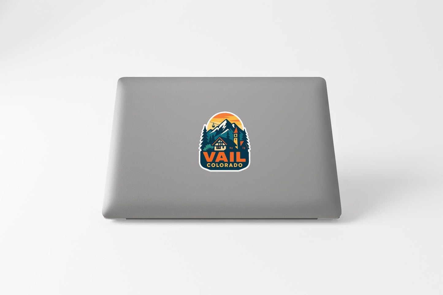A sticker on the back of a laptop that says "Vail Colorado".