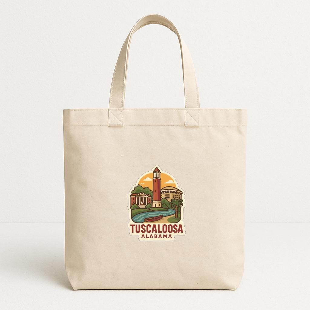 A beige tote bag with a printed design depicting a landmark in Alabama, specifically the Tuscaloosa Alfa-Majestic Tower.