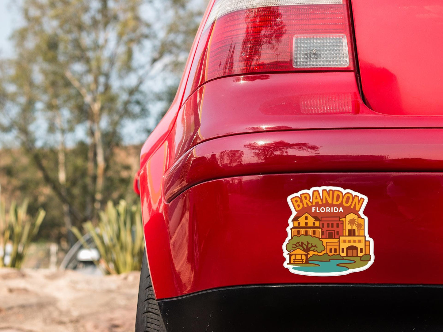 the rear end of a red car with a sticker on the trunk that says "Branson, Florida".