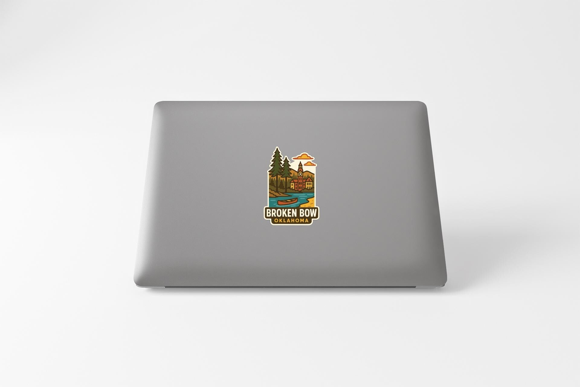 a sticker with a nature-themed illustration on the back of a laptop.