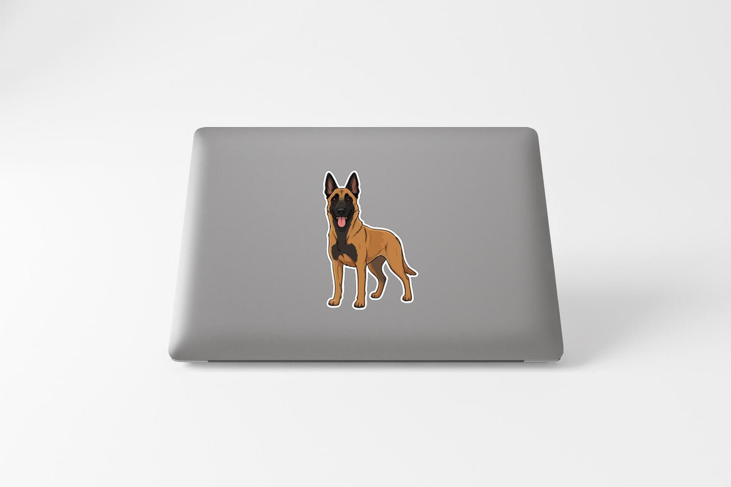 A sticker of a brown dog with a black face and ears is displayed on the back of a laptop.