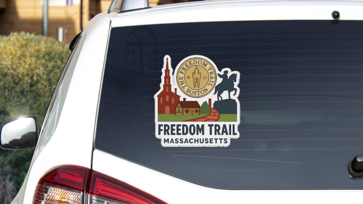 a sticker on the rear window of a vehicle, depicting a scenic view of Freedom Trail in Massachusetts.